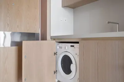 a kitchen with a washing machine in a kitchen at Blueground The Palm Jumeirah pool nr Marina DXB-1711 in Dubai