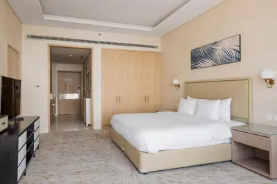 a hotel room with a large bed and a television at Blueground The Palm Jumeirah pool nr Atlantis DXB-1717 in Dubai