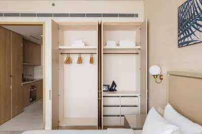 a bedroom with a door that leads into a kitchen at Blueground The Palm Jumeirah pool nr Atlantis DXB-1717 in Dubai