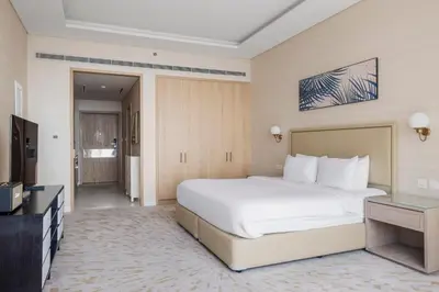 a bedroom with a large white bed and a television at Blueground The Palm Jumeirah jacuzzi nr Atlantis DXB-1720 in Dubai