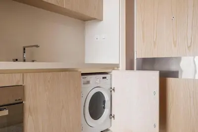 a kitchen with a washing machine in a kitchen at Blueground The Palm Jumeirah jacuzzi nr Atlantis DXB-1720 in Dubai