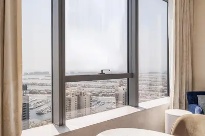 a room with a window with a view of a city at Blueground The Palm Jumeirah jacuzzi nr Atlantis DXB-1720 in Dubai