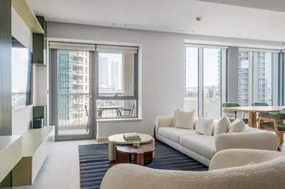 a living room with a couch and a table at Blueground Downtown Dubai pool nr Burj Khalifa DXB-1735 in Dubai