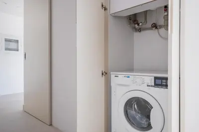 a laundry room with a washer and dryer at Blueground Downtown Dubai pool nr Burj Khalifa DXB-1735 in Dubai