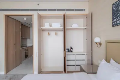 a bedroom with a door leading to a kitchen at Blueground The Palm Jumeirah pool nr Atlantis DXB-1722 in Dubai