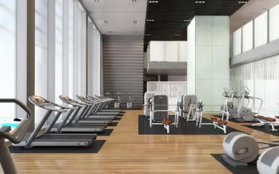 a gym with a row of treadmills and machines at Blueground DIFC pool nr Dubai Mall DXB-1743 in Dubai