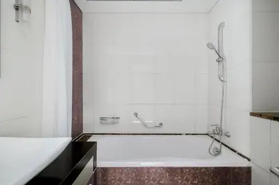 a bath tub in a bathroom with a shower at Blueground JLT pool nr Lake DXB-1747 in Dubai