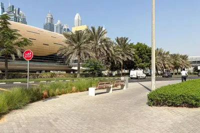 a stop sign next to a street with palm trees at Blueground JLT pool nr Lake DXB-1747 in Dubai
