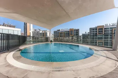 a swimming pool on the roof of a building at StayShort - Modern 1 Bed in Meydan Sleeps 4 in Dubai