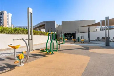 a group of playground equipment in front of a building at StayShort - Modern 1 Bed in Meydan Sleeps 4 in Dubai