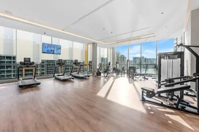 a gym with treadmills and machines in a building at StayShort - Modern 1 Bed in Meydan Sleeps 4 in Dubai