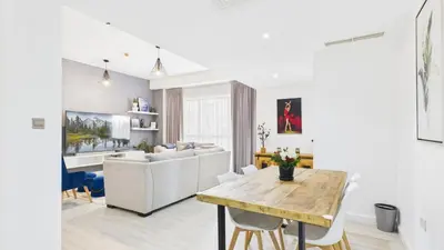a living room with a table and a couch at Spacious 2 BR with Sea and Marina View Bahar JBR in Dubai