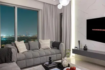 a living room with a couch and a flat screen tv at Modern 2BR Apartments near Dubai Mall, Downtown in Dubai