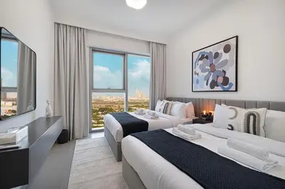 a hotel room with two beds and a television at Modern 2BR Apartments near Dubai Mall, Downtown in Dubai