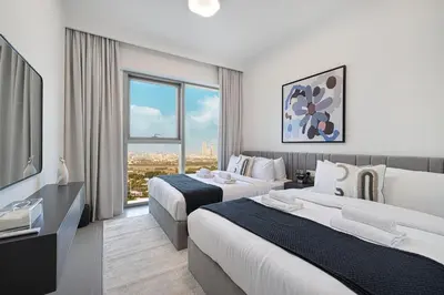 a hotel room with two beds and a television at Modern 2BR Apartments near Dubai Mall, Downtown in Dubai