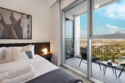 a bedroom with a bed and a large window at Modern 2BR Apartments near Dubai Mall, Downtown in Dubai