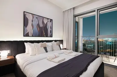 a bedroom with a large bed and a large window at Modern 2BR Apartments near Dubai Mall, Downtown in Dubai