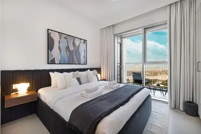 a bedroom with a large bed and a large window at Modern 2BR Apartments near Dubai Mall, Downtown in Dubai