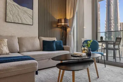 a living room with a couch and a table at 2BR - Private Cinema - Pool - Walk to Burj Khalifa in Dubai