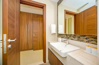 a bathroom with a sink and a mirror at Premium 2BR at Imperial Avenue overlooking Burj Khalifa in Dubai