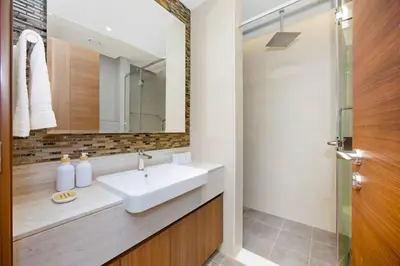 a bathroom with a sink and a mirror at Premium 2BR at Imperial Avenue overlooking Burj Khalifa in Dubai