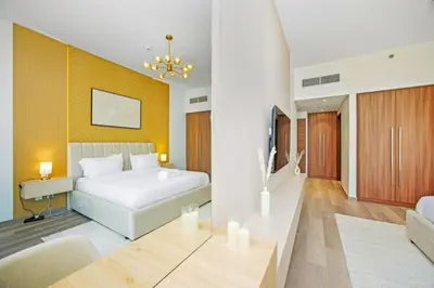 a bedroom with a bed and a desk in a room at Premium 2BR at Imperial Avenue overlooking Burj Khalifa in Dubai