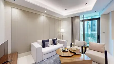 a living room with a white couch and a table at Vacationer l Modern 1 Bedroom l City Views l Prime Location in Dubai