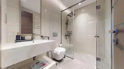 a bathroom with a sink and a shower and a toilet at Vacationer l Modern 1 Bedroom l City Views l Prime Location in Dubai