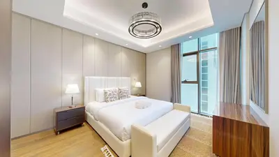 a bedroom with a white bed and a large window at Vacationer l Modern 1 Bedroom l City Views l Prime Location in Dubai