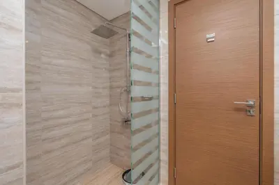 a shower with a wooden door in a bathroom at Vacay Lettings - Missoni Luxury 2 BR Urban Oasis Dubai Canal View in Dubai