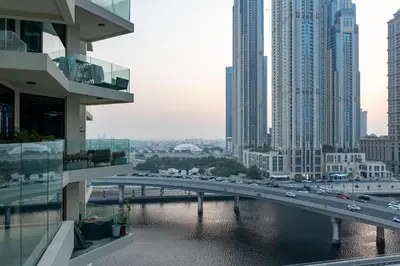 a bridge over a river in a city with buildings at Vacay Lettings - Missoni Luxury 2 BR Urban Oasis Dubai Canal View in Dubai