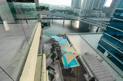 an overhead view of a swimming pool on a building at Vacay Lettings - Missoni Luxury 2 BR Urban Oasis Dubai Canal View in Dubai