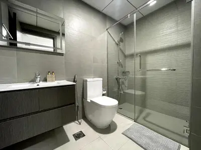 a bathroom with a toilet and a sink and a shower at Stunning New Studio - Near Dubai Hills Mall in Dubai