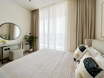 a bedroom with a large bed and a mirror at Elegant 1BR Unit with Premium Finish in Dubai