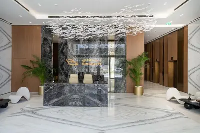 a lobby with a large marble table and chairs at Elegant 1BR Unit with Premium Finish in Dubai