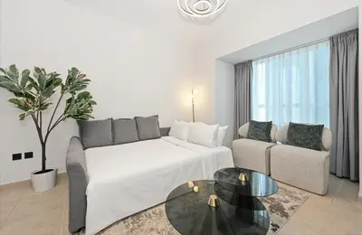 a living room with a couch and a table at Luxury 1BD in Elite Residence, Dubai Marina in Dubai