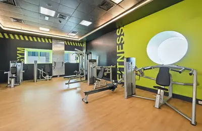 a gym with several treadmills and cardio machines at Luxury 1BD in Elite Residence, Dubai Marina in Dubai