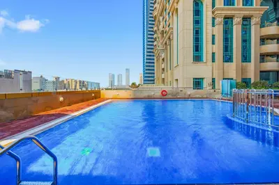 a large swimming pool on top of a building at Luxury 1BD in Elite Residence, Dubai Marina in Dubai