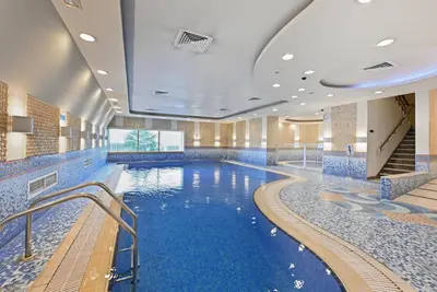 a pool in a hotel with blue water at Luxury 1BD in Elite Residence, Dubai Marina in Dubai