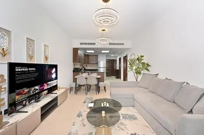 a living room with a couch and a tv at Luxury 1BD in Elite Residence, Dubai Marina in Dubai