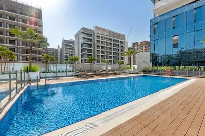 a swimming pool in a city with buildings at Charming 2BR Getaway at Azizi Riviera, MBR City in Dubai
