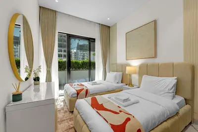 a hotel room with two beds and a mirror at Charming 2BR Getaway at Azizi Riviera, MBR City in Dubai
