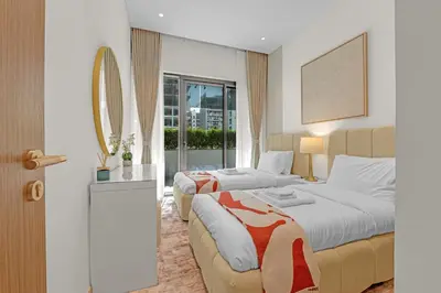 a hotel room with two beds and a window at Charming 2BR Getaway at Azizi Riviera, MBR City in Dubai