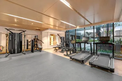 a gym with treadmills and ellipticals in a building at Charming 2BR Getaway at Azizi Riviera, MBR City in Dubai