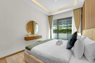 a bedroom with a bed with a mirror and a window at Charming 2BR Getaway at Azizi Riviera, MBR City in Dubai