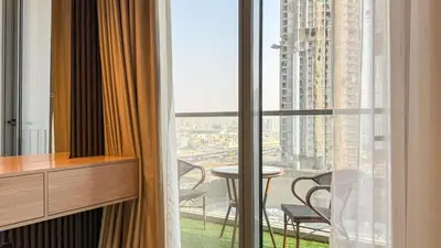 a room with a large window with a table and chairs at 1BDR near Circle Mall with Sauna, Jaccuzzi and Gym in Dubai