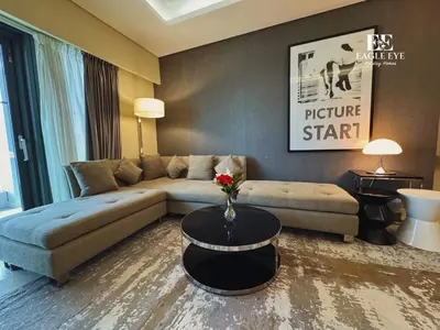 a living room with a couch and a table at EagleEye Paramount Tower D 1BR Sleeps 4 in Dubai