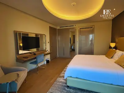 a bedroom with a bed and a desk and a television at EagleEye Paramount Tower D 1BR Sleeps 4 in Dubai