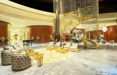 a large lobby with a grand piano and furniture at EagleEye Paramount Tower D 1BR Sleeps 4 in Dubai