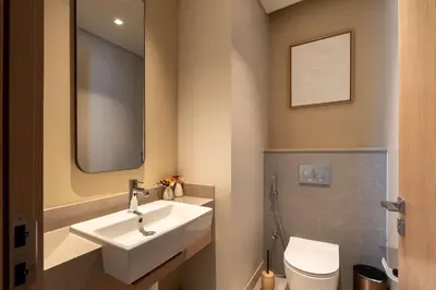 a bathroom with a sink and a toilet and a mirror at PVH - Burj Khalifa View 2BR - Vida Dubai Mall in Dubai